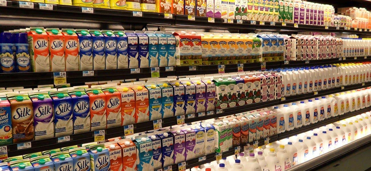 Milk Different brands of milk on a shelves