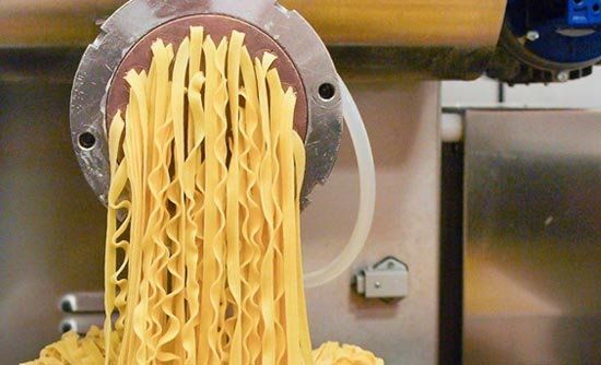 Fresh pasta coming out of a machine