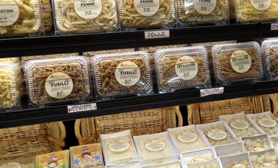 Fresh cut pasta in containers on shelves