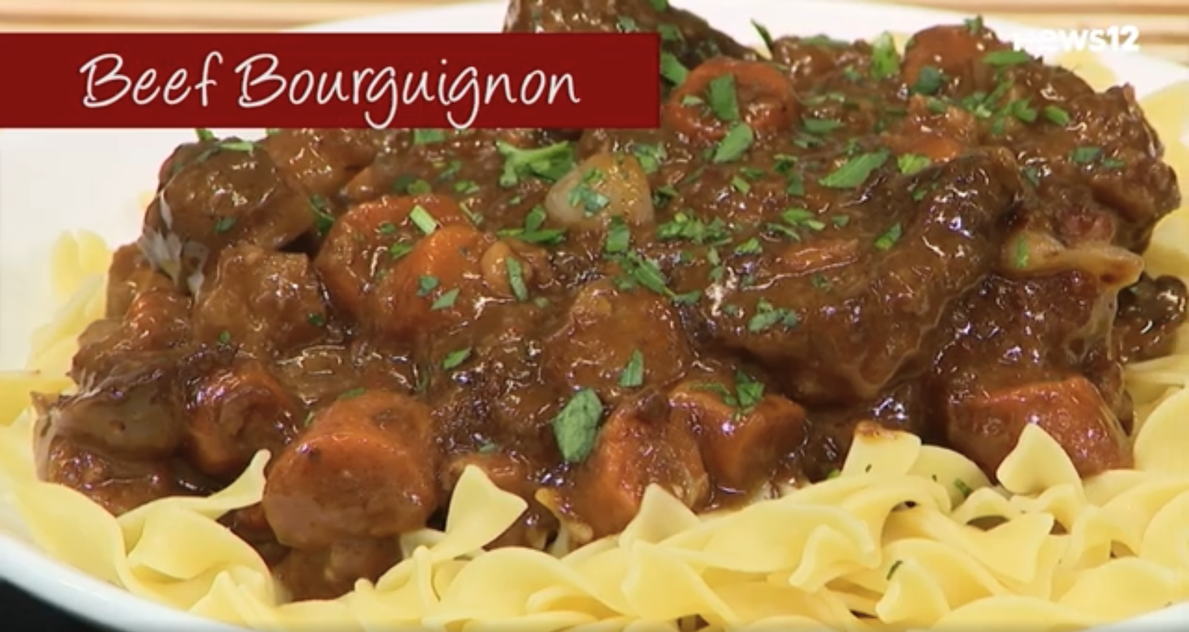 Beef bourguignon over egg noodles