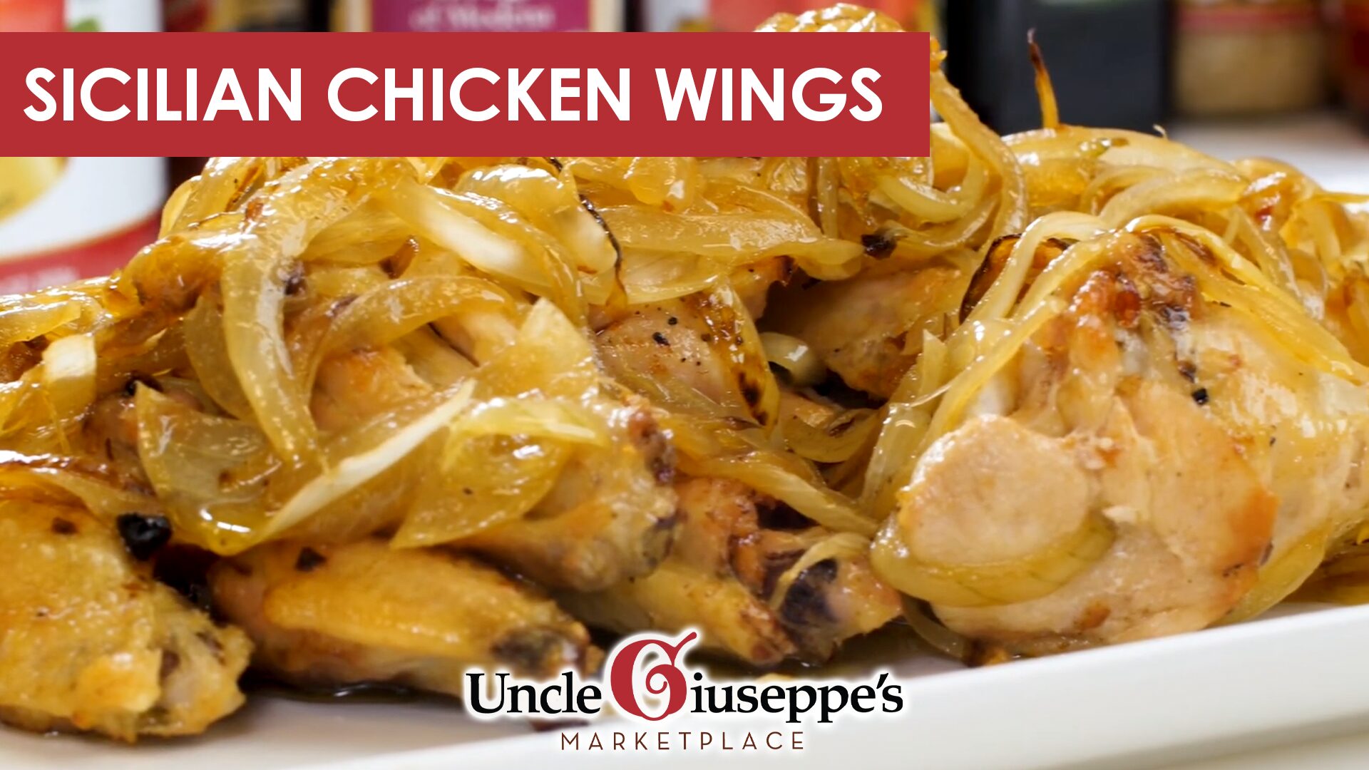 Close up of chicken wings and onions on a white plate