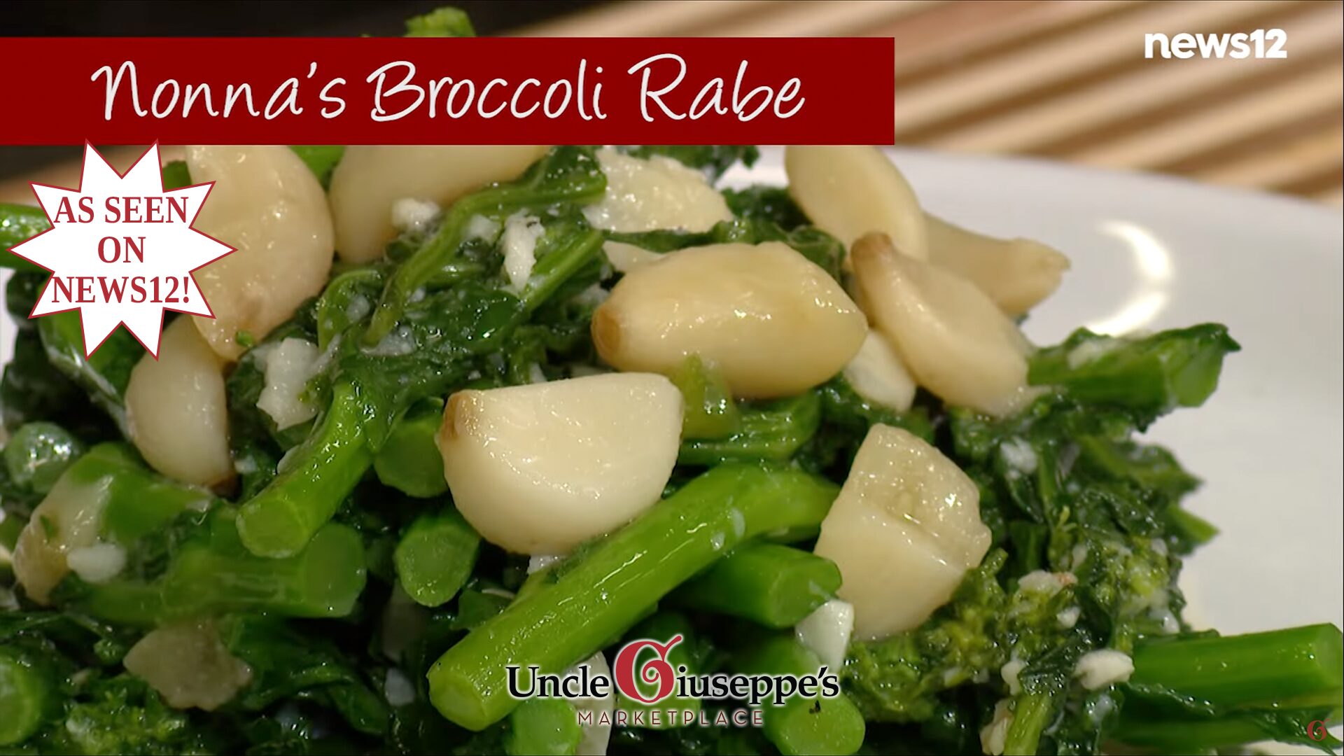 Cooked broccoli rabe and garlic cloves on a white plate