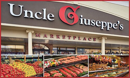 Exterior storefront of Uncle Giuseppe's with three boxes with fresh bell peppers, butcher case and groceries below it