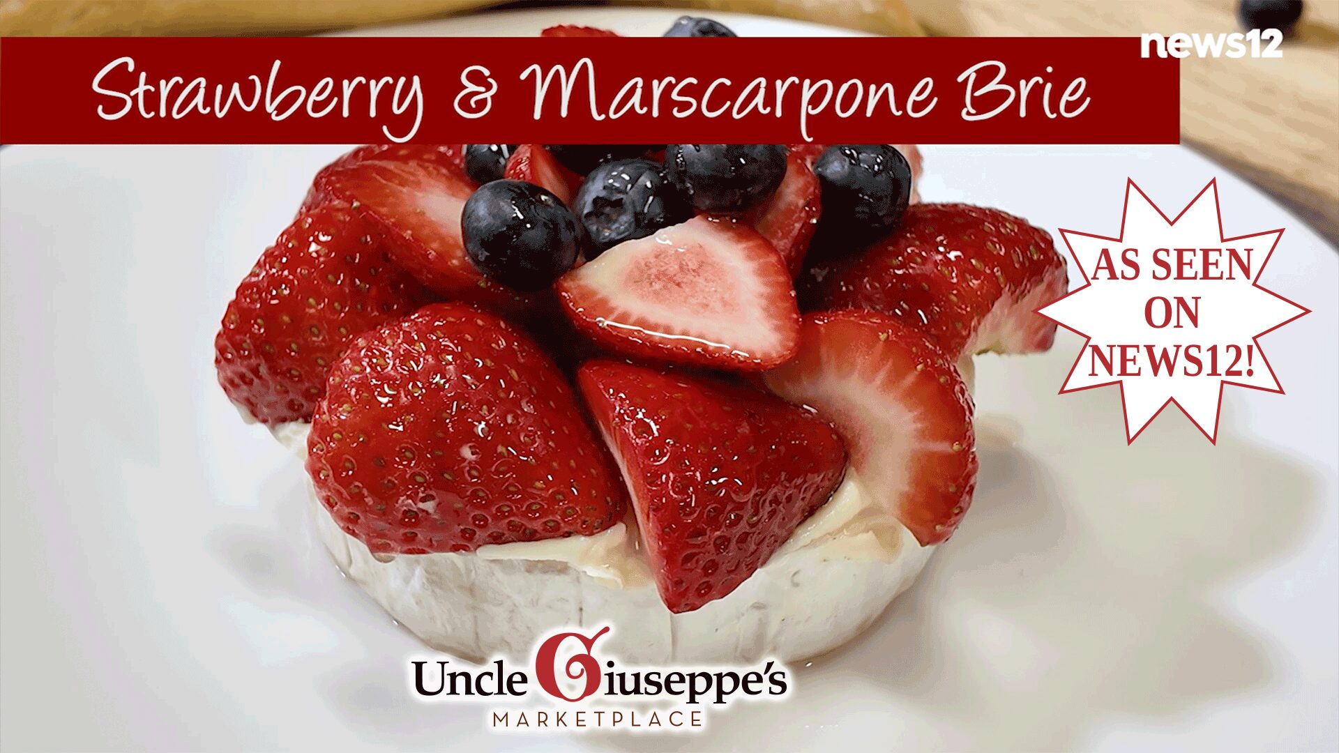 Close up of a wheel of brie topped with berries on a white plate