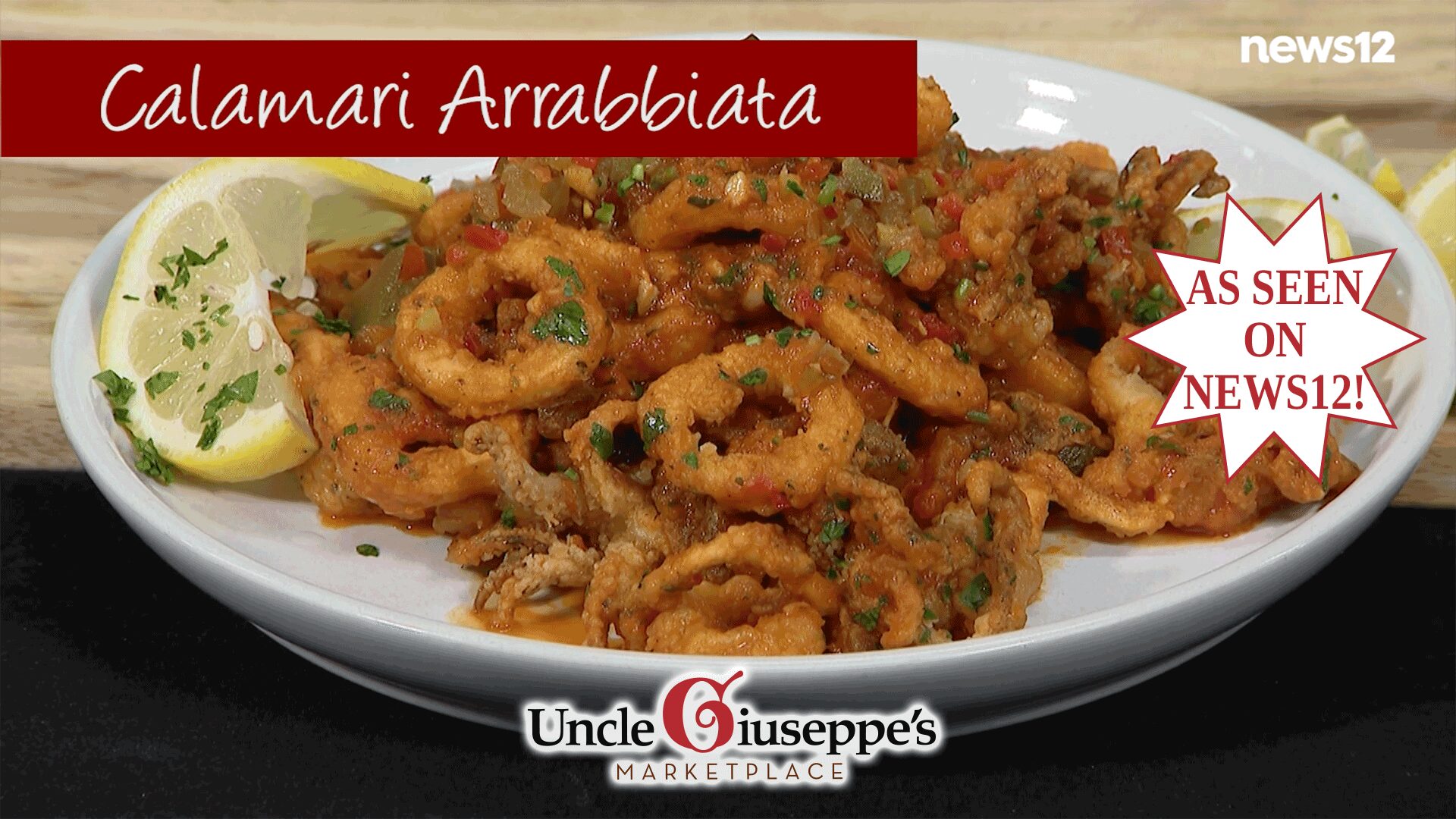 Fried calamari tossed in a red sauce on a white plate