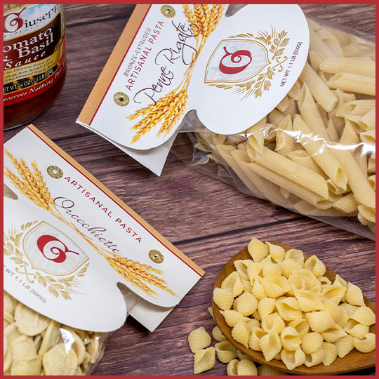 Uncle Giuseppe's artisanal pastas on a wood background